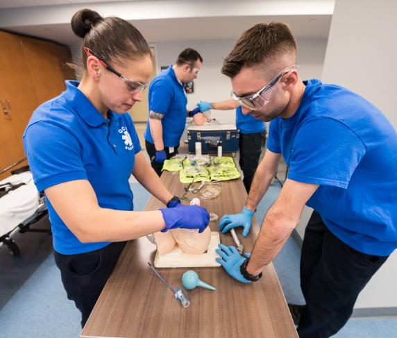 Two paramedic students work in a lab on the downtown campus