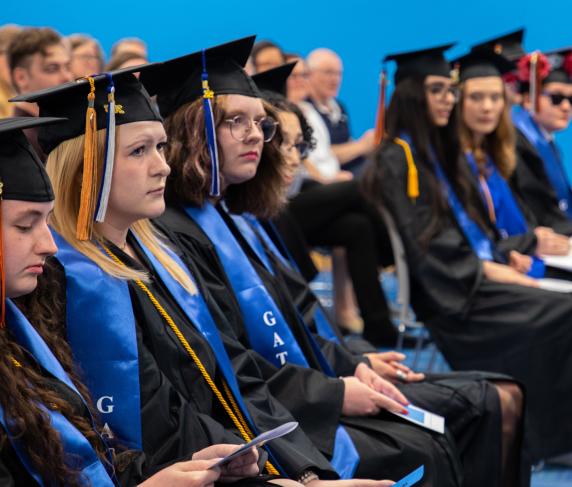 Gateway to college graduates sit at commencement
