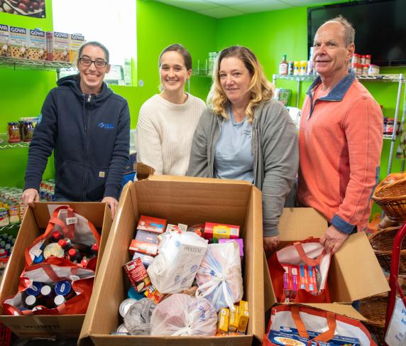 From left: Jodie Bastarache from Elm Electrical, food pantry staff members Julia Rooney and Cheryl Marrino, and Mark Laverdure, who drives the truck for the food pantry