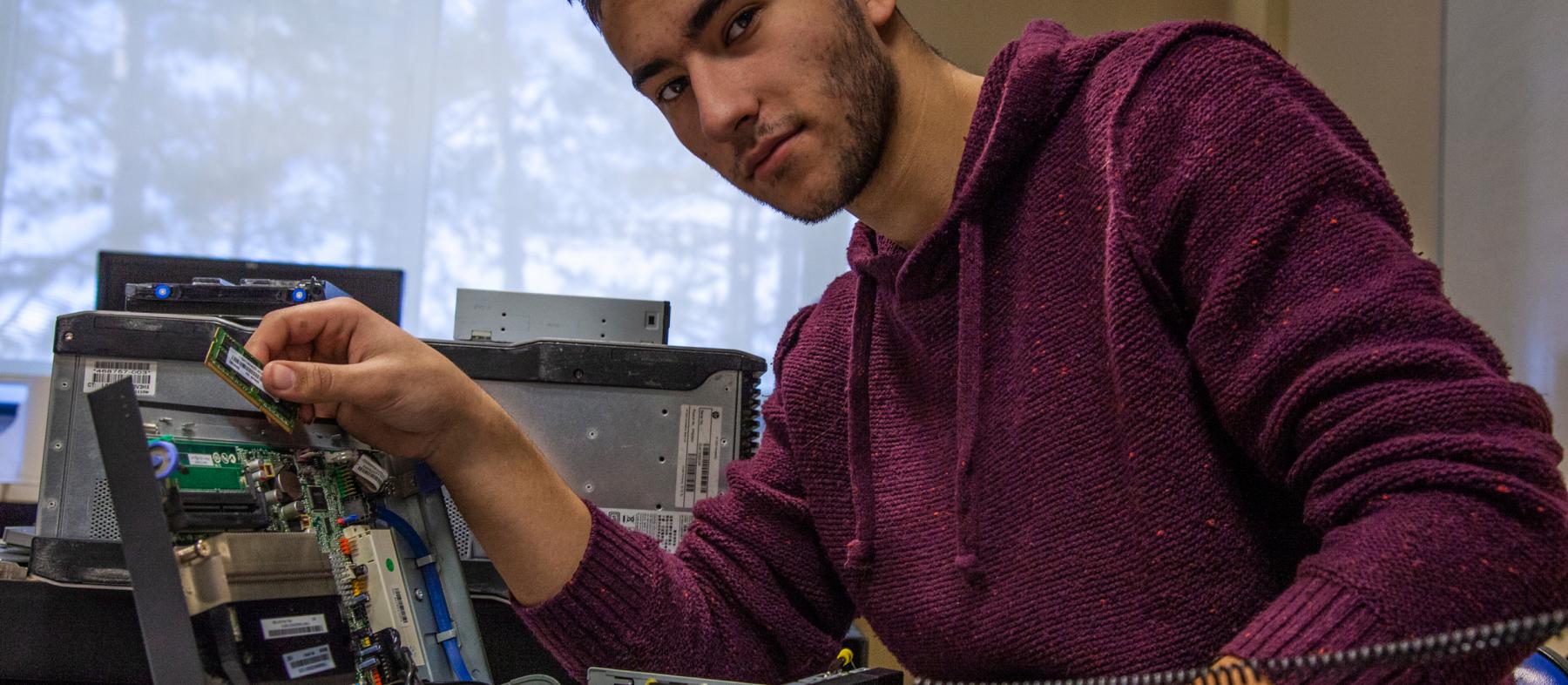 A student places components in a hand-built computer