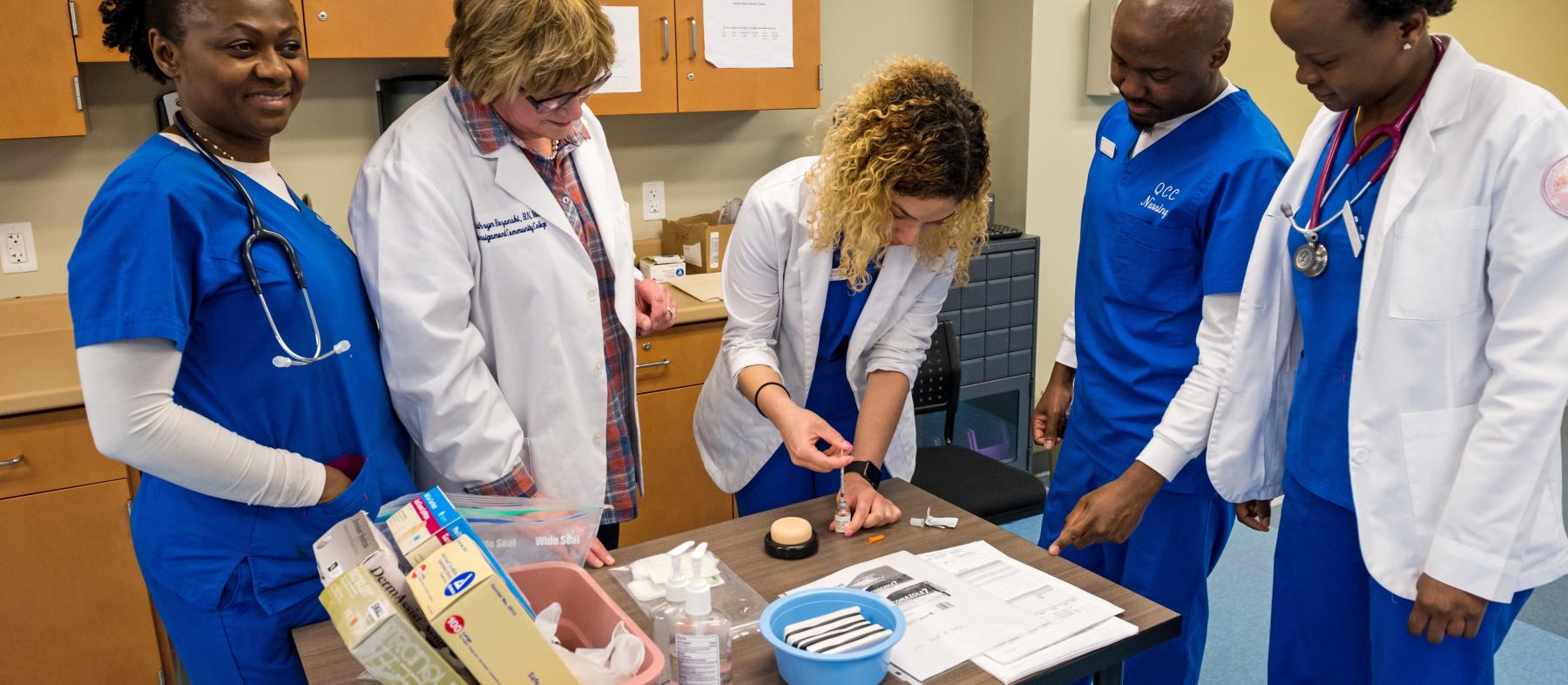 Nursing students gather to learn about medical instruments