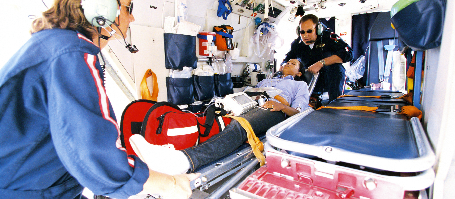 EMTs pull a patient into the ambulance