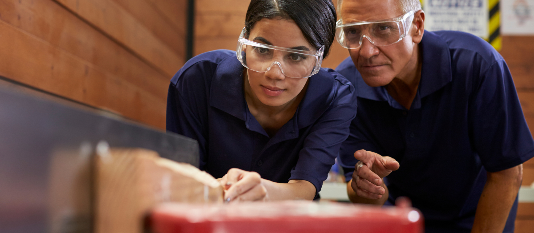 A student wears safety goggles in an apprenticeship enviroment