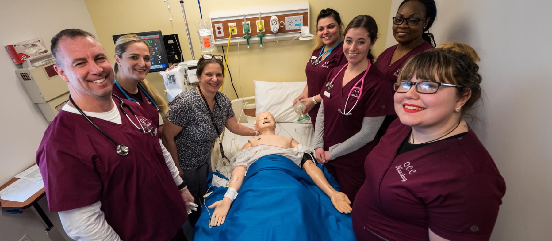 A class of nursing students with a test dummy