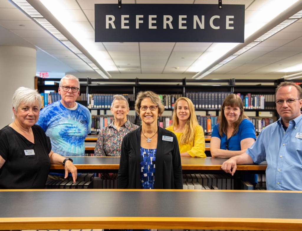 QCC’s library staff gather at the reference desk