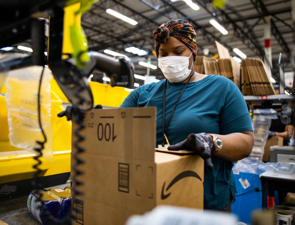 A woman works with packaging in an Amazon warehouse