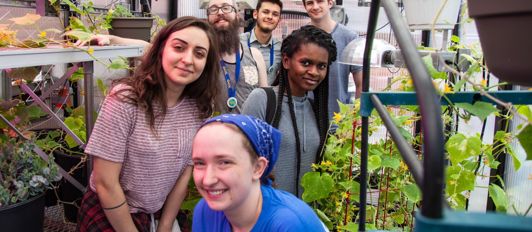 PTK students pose in the campus greenhouse