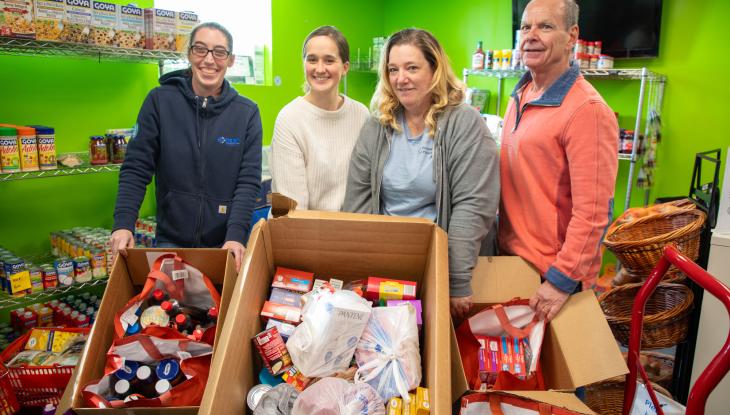 From left: Jodie Bastarache from Elm Electrical, food pantry staff members Julia Rooney and Cheryl Marrino, and Mark Laverdure, who drives the truck for the food pantry