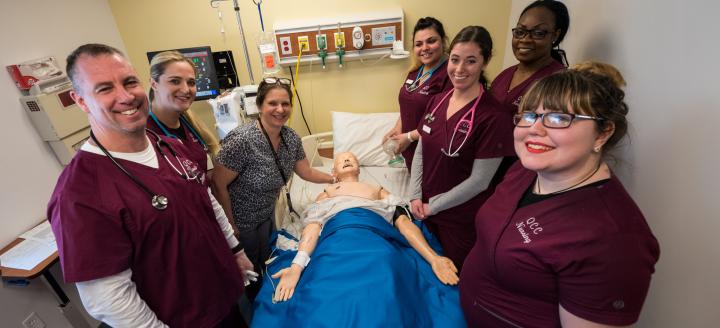 A class of nursing students with a test dummy