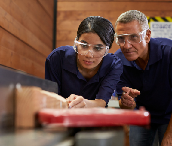 A student wears safety goggles in an apprenticeship enviroment