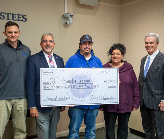 (from left) Assistant Director of Athletics & Fitness Center Josh Cole, QCC President Dr. Luis Pedraja, Men’s Head Baseball Coach Corey Coleman, Director of Athletics & Fitness Center Lisa Gurnick and Worcester County District Attorney Joe Early, Jr.