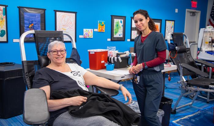 Assistant Director of Operations for External Affairs Shirley Dempsey (left) donating blood.