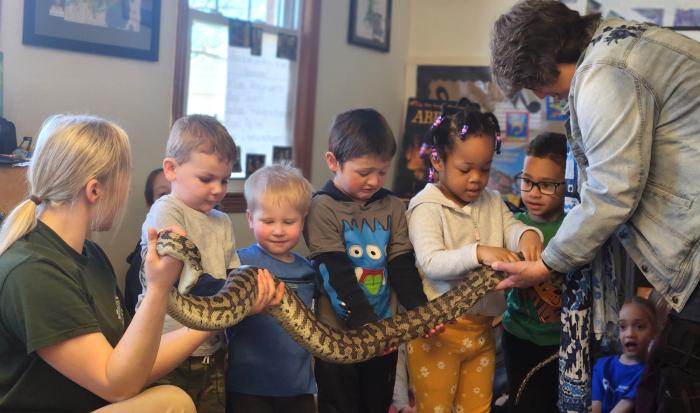 Students get to hold a carpet python.