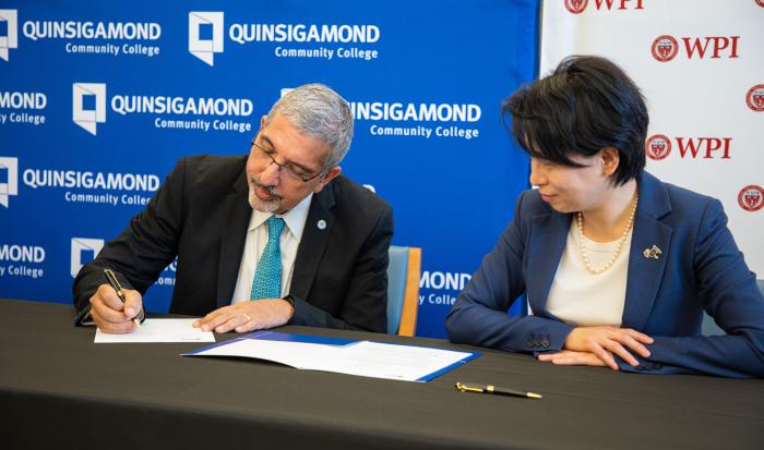 QCC President Dr. Luis Pedraja (left) signing the articulation agreement with WPI President Dr. Grace Wang.