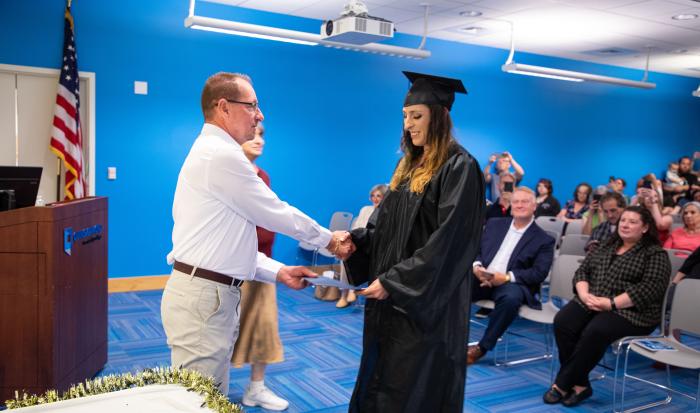 HSE/GED graduate Maria Snell receives a handshake from ACLC Case Manager Richard Nevalsky.