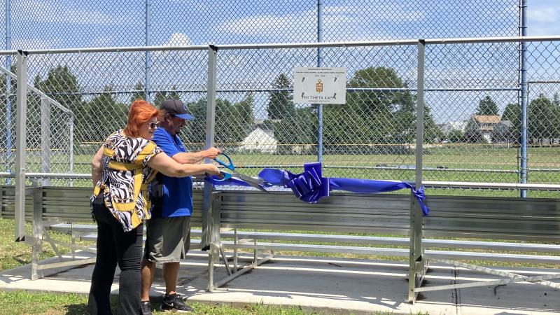 Former PTK President Kimberly Lindsey and Men's Baseball Coach Corey Coleman at the ribbon cutting for the new bleachers donated by PTK.